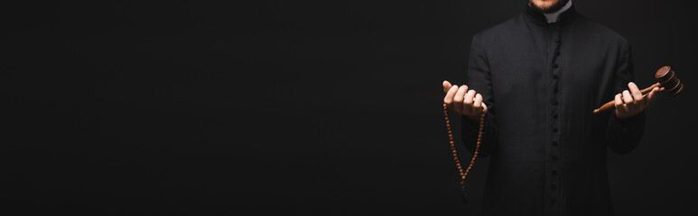 Sticker - panoramic shot of priest holding wooden gavel and rosary beads in hands isolated on black
