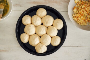 Sticker - Process of making delicious cheese bubble pizza bread with ingredients and cheese on a white table