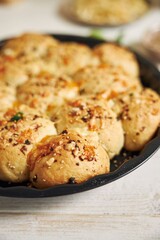 Sticker - Freshly-made delicious cheese bubble pizza bread with ingredients and cheese on a white table