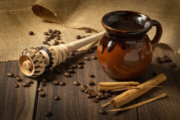 Wall Mural - High angle shot of cinnamon, coffee and a wooden tool for making coffee