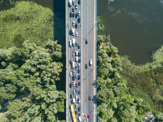 Aerial drone view. Cars travel along the North Bridge over the Dnieper River in Kiev. Summer sunny day.