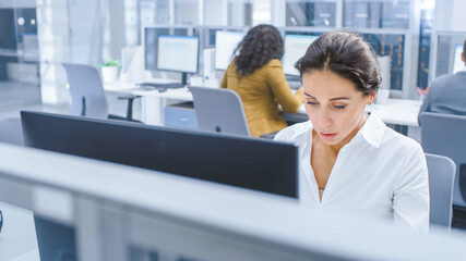 Aufkleber - Beautiful Businesswoman, Economist, Stock Broker Uses Desktop Computer, Typing on a Keyboard, Working Documents, Graphs and Statistics. in the Background Big Corporate Firm Office