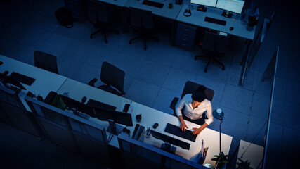 Aufkleber - Alone Working Late at Night in the Office: Businesswoman Using Desktop Computer, Analyzing, Using Documents, Solving Problems, Finishing Project. High Angle Shot