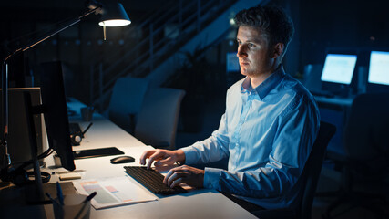 Aufkleber - Portrait of Ambitious and Confident Businessman Uses Desktop Computer, Typing on a Keyboard, Monitoring Business Transactions, Signing Contracts. Works Late at Night in Big Corporate Office