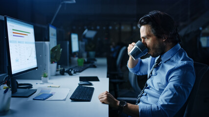Aufkleber - In the Office at Night Overworked Tired Office Worker Uses Desktop Computer Drinks Coffee. Tired Exhausted Businessman Finishing Important Project
