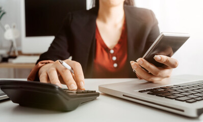 businesswoman hand using smart phone, tablet payments and holding credit card online shopping, omni channel, digital tablet docking keyboard computer at office in sun light