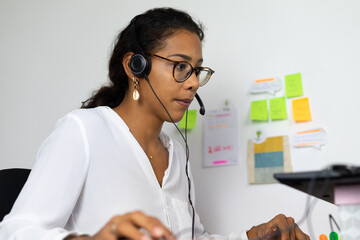 Wall Mural - Young brazilian woman working from home