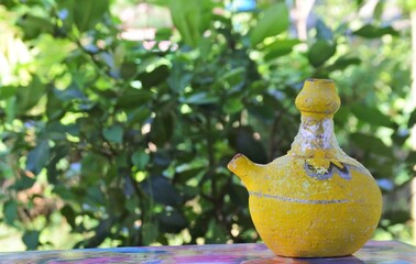 Sticker - Selective focus shot of colorful handmade objects with the garden in the background