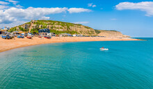 A View From The Sea Towards The Beach And East Cliffs In Hastings, Sussex In Summer