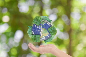 Canvas Print - save earth concept. hands with earth and recycle logo over green nature background. element of the i
