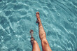Leinwandbild Motiv Woman legs playing in the pool