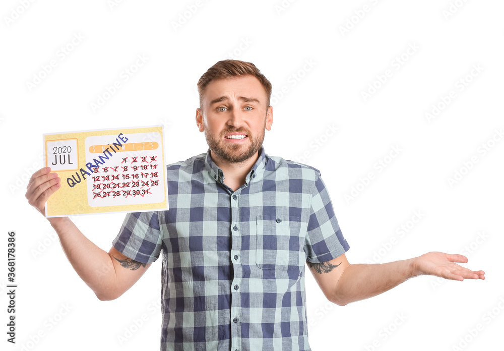Troubled man holding calendar with written word QUARANTINE against white background
