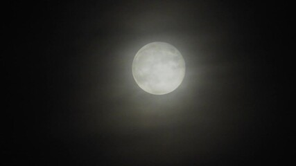 moon with clouds at night. spooky scene with full moon and clouds on a dark night