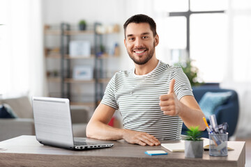 Poster - technology, remote job and business concept - happy smiling man with laptop computer showing thumbs up at home office