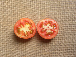 Wall Mural - Cut halves of orange color fresh ripe tomato