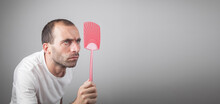Caucasian Man Holding A Fly Swatter.