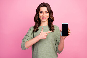 Wall Mural - portrait of positive cheerful girl promoter hold smartphone new device point index finger recommend 
