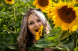 Close-up portrait of beautiful woman with sunflower