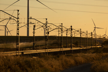 Train tracks landscape and wind turbines in Spain