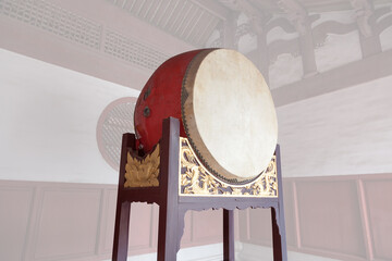 Traditional Chinese big drum on wooden frame with dragon relief in a temple, this traditional drum were usually pounded  in sacrificial rites or festivals in ancient times