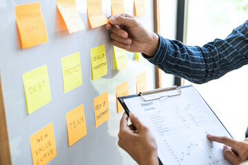 Poster - Two creative meeting and planning use post it notes on board to share idea