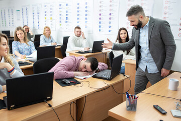 Wall Mural - Tired student sleeping in the middle of a class