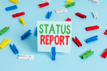 Poster - Writing note showing Status Report. Business concept for summarizes the particular situation as of a stated period Colored clothespin papers empty reminder blue floor officepin