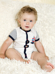 Wall Mural - portrait of a beautiful little boy with curly hair