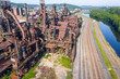 © ChristyLangPhotos - Aerial of abandoned steel factory in Pennsylvania with train tracks and a river alongside.