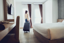 Tourist Woman With Luggage In Hotel After Check-in. Conceptual Of Travel And Vacation.