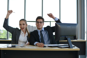 Business people sitting at desk and working with laptop computer.