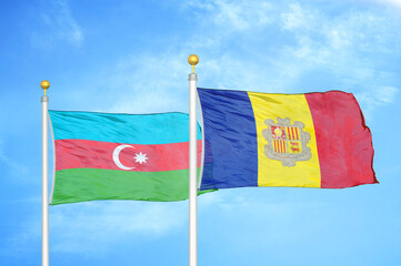 Azerbaijan and Andorra two flags on flagpoles and blue sky