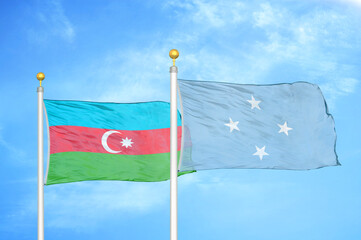 Azerbaijan and Micronesia two flags on flagpoles and blue sky