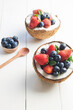 © Dani Rendina/Austockphoto - Halved coconuts filled with berries