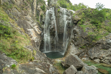 Panoramic beautiful and wild waterfall in switzerland, Ticino near Maggia Valley.