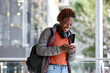 © Jonah Ritchie/Austockphoto - African woman having fun in city checking mobile phone