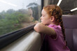 © Kathryn Jewkes/Austockphoto - Young girl looking out the window of a train