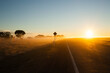 © Justin Hevey/Austockphoto - Sunrise on a  regional highway with silhouette road side sign