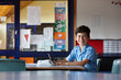 © Jonah Ritchie/Austockphoto - Happy young school boy writing in classroom