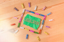 Conceptual Hand Writing Showing Legislation. Concept Meaning The Exercise Of The Power And Function Of Making Rules Colored Crumpled Papers Wooden Floor Background Clothespin