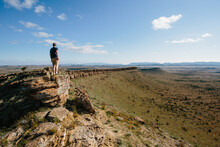 A Man In Hiking Gear Overlooking The Rugged Landscape Of The Flinders Ranges