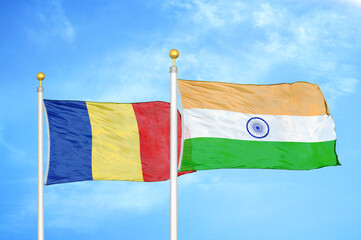 Romania and India two flags on flagpoles and blue sky