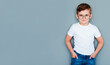 © Яна Солодкая - Portrait of a little boy with glasses on a gray background