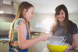 © Tom Merton/Caia Image - Happy mother and daughter baking in kitchen