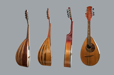 Wall Mural - Four different mandolins arranged vertically mandolins isolated on gray background.