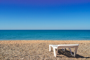 Wall Mural - White empty sun lounger on the beach