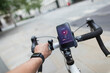 © Paul Bradbury/Caia Image - POV man riding bicycle with smart phone health monitor