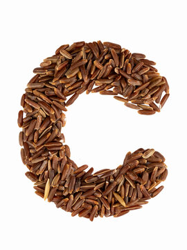Letter C of the English alphabet made from brown rice on an isolated background.