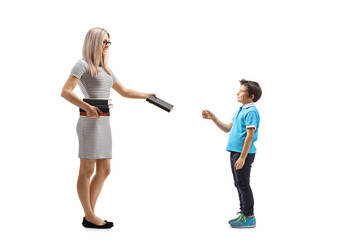 Poster - Young female teacher giving a book to a male pupil