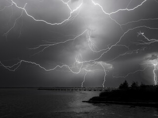 Wall Mural - Lightning at night over water